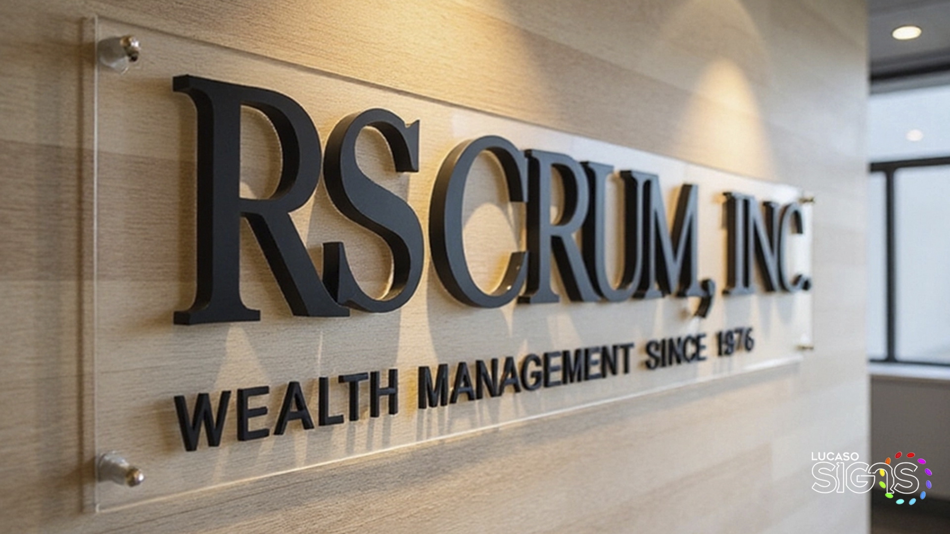 Custom 3D lobby sign with raised black acrylic letters on clear panel by Lucaso Signs