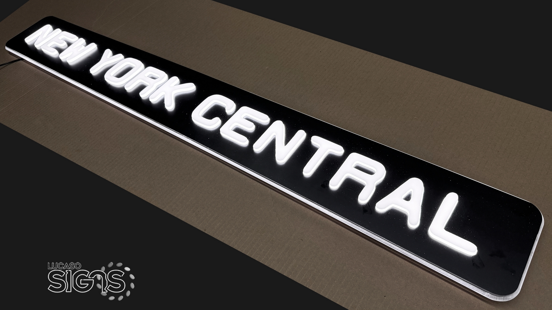 Custom push-through illuminated sign with white glowing letters spelling New York Central by Lucaso Signs