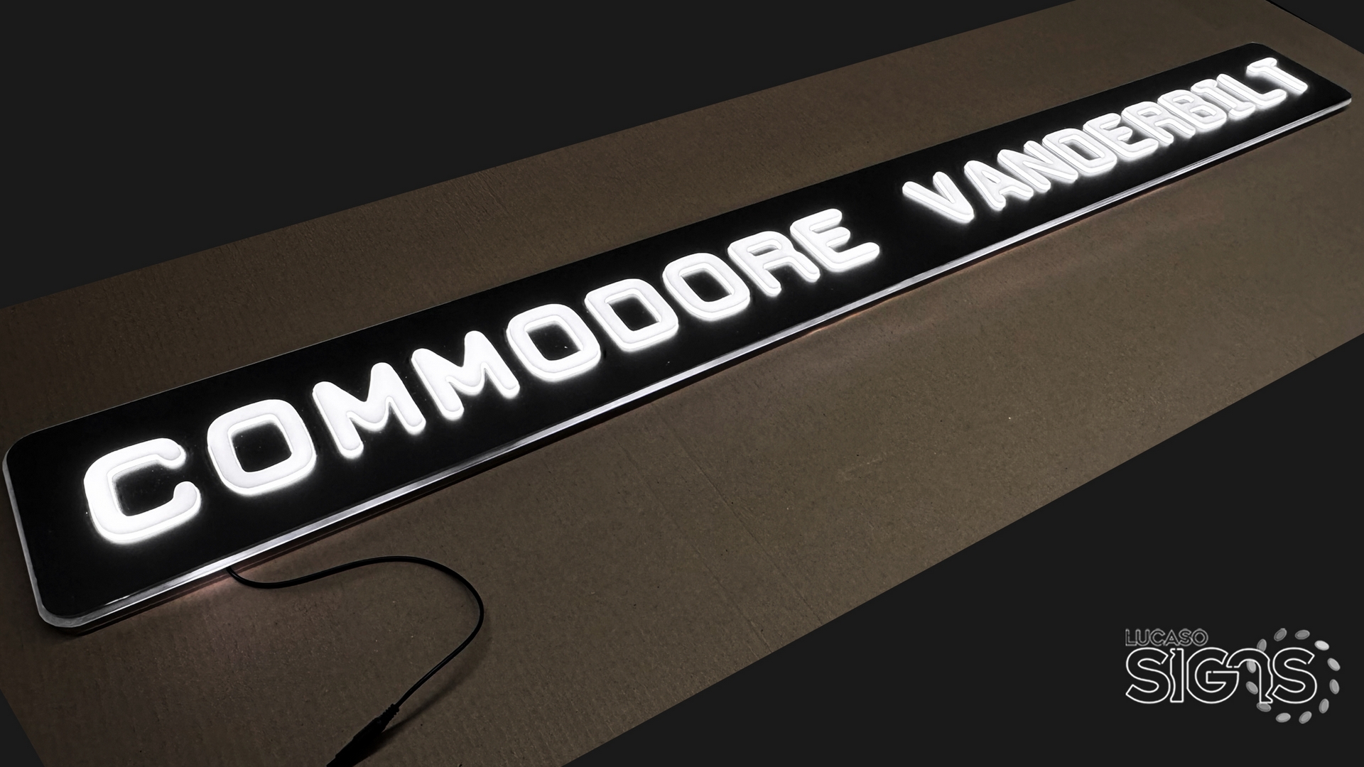 Custom push-through illuminated sign with white glowing letters spelling Commodore Vanderbilt by Lucaso Signs